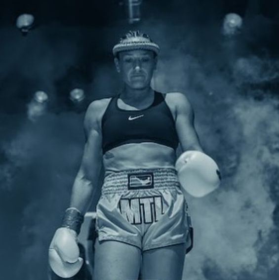 Mardi walking out to the ring in her mongkol and gloves