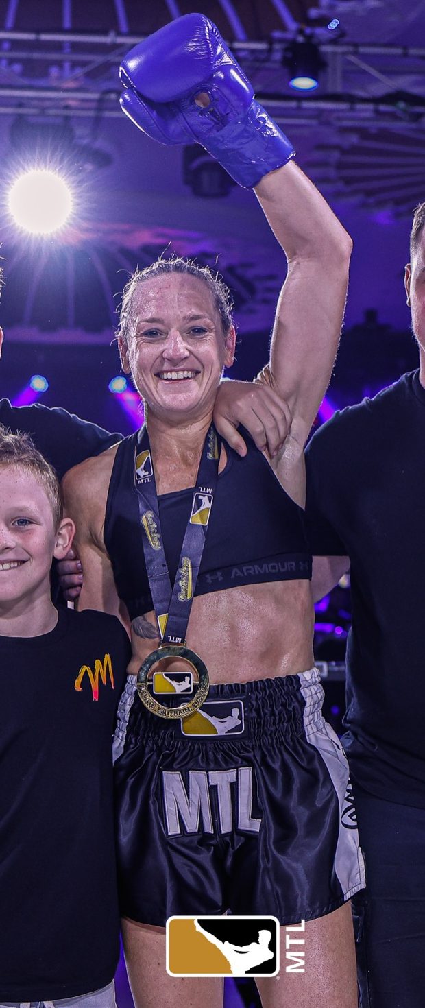Mardi with her glove raised and medal after a win